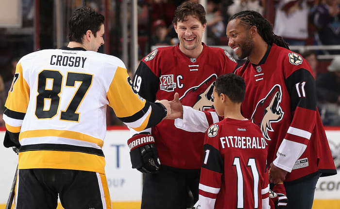 Larry Fitzgerald greeted Sidney Crosby and Shane Dolan before dropping the puck Saturday night.